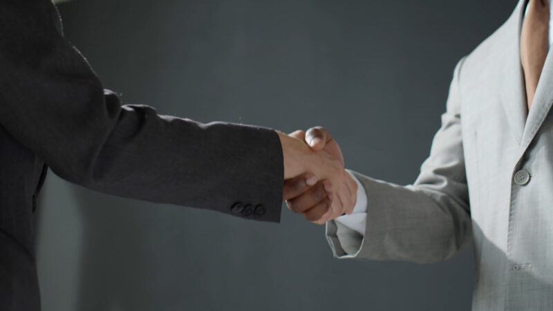 Coworkers shaking hands after closing the deal