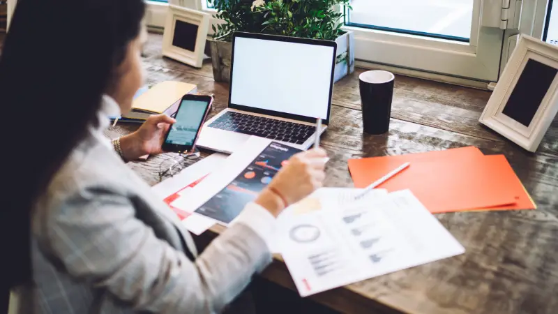 Entrepreneur reviewing reports and data at a desk