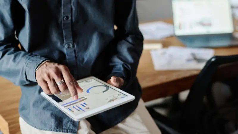 Founder reviewing business metrics on a tablet