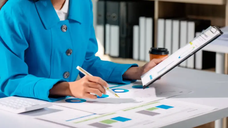 Founder reviewing charts and reports on a desk, showing practical analytical skill in business analysis